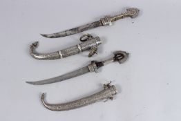 TWO 19TH CNENTURY MOROCCAN SILVER MOUNTED KOMAYA DAGGERS.