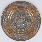 A FINE SOUTH INDIAN TANJORE SILVER AND COPPER OVERLAID BRASS DISH depicting Hindu deities. 9ins