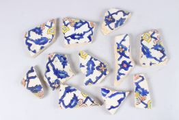 A COLLECTION OF ELEVEN 17TH - 18TH CENTURY PERSIAN SAFAVID GLAZED CUERDA SECA TILE FRAGMENTS.