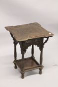 AN ISLAMIC CARVED SQUARE TWO TIERED TABLE with allover carved decoration. 1ft 7ins square