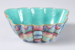 A CHINESE SHAPED COLOURFUL BOWL. Impressed mark. 8ins long.