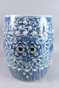 A LATE 19TH CENTURY CHINESE BLUE AND WHITE PORCELAIN BARREL SEAT, painted with an all over floral