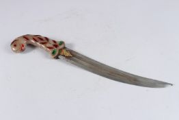 AN INDIAN MUGHAL STYLE DAGGER with partially gilded curving blade, the hardstone handle inset with