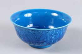 A CHINESE BLUE PORCELAIN BOWL, the sides with dragons. Six character mark. 6ins diameter.