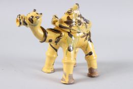 A TURKISH POTTERY CAMEL FIGURE. 8ins high.