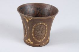 A PERSIAN METAL GOLD INLAID HOOKAH BASE with oval panels of figures and flowers. 3ins.