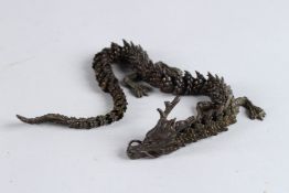 A BRONZE OKIMONO OF AN ARTICULATED DRAGON, 15in long.