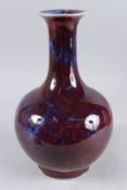 A CHINESE BULBOUS SHAPED FLAMBE GLAZED BOTTLE VASE, 13in high.