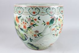 A 19TH CENTURY CHINESE PORCELAIN JARDINIERE, painted with birds, flowers and butterflies, 12in