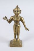 AN INDIAN BRONZE STANDING FIGURE. 8.5ins high.