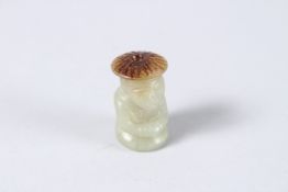 A TINY CARVED JADE FIGURE. 1.5ins high.