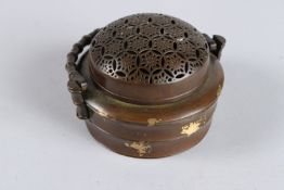 A CHINESE BRONZE GOLD SPLASH CIRCULAR CENSER with swing handle. 3ins diameter.