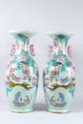 A SUPERB PAIR OF 19TH CENTURY CHINESE PORCELAIN VASES decorated in brilliant colours with many
