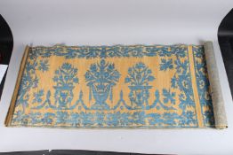 AN ISLAMIC EMBROIDERED PANEL unframed, cream ground, embroidered in blue depicting stylised urns