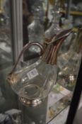 A stylish cut glass and silver plated mounted claret jug.