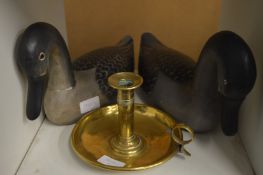 Two painted carved wood ducks and a brass chamberstick.