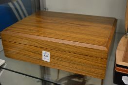 Humidor containing a quantity of cigars.