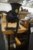 A cast iron table mounted coffee grinder and a boxed cast iron Spong's patent bean slicer.