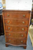 A small mahogany chest of drawers.