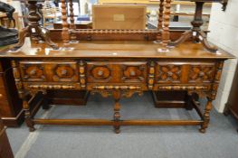 An oak Jacobean Revival three drawer sideboard.