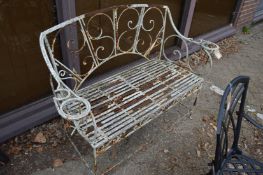 A wrought iron garden bench.