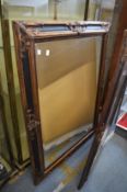 A large Victorian style mirror with decorative frame.