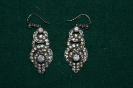 A pair of decorative earrings.