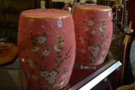 A pair of Chinese style pink pottery garden seats decorated with birds on branches.