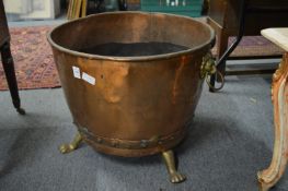 A copper and brass log bin.