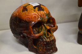 An amber style model of a skull.