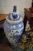 A pair of Chinese floor standing blue and white temple jars and covers.