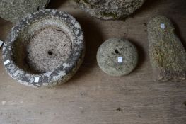 A stone circular trough and two other items.