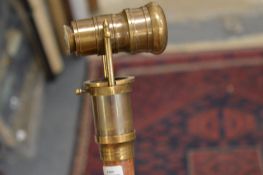 A walking stick, the handle mounted with a telescope.
