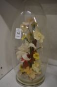 A floral display under a glass dome.