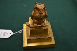 A good cast gilt metal model of an owl seated on a pedestal base, possibly a pen holder.