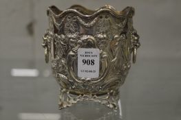 A silver bowl with wavy edge, lion mask handles and embossed decoration.