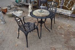 A black painted aluminium three piece patio set comprising circular table and pair of armchairs.