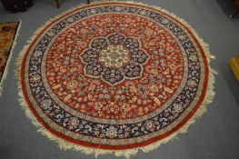 A circular Persian style rug, 180cm diameter.