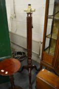 A mahogany standard lamp with tripod base.