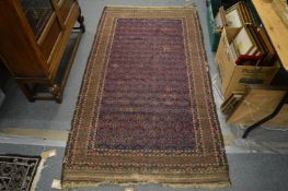 Persian rug, worn, 190cm x 106cm.