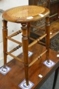 A cane seated stool.