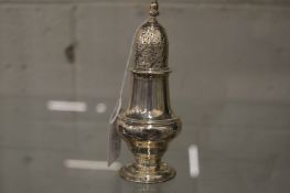 A silver baluster shaped pepperette.