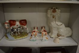 A group of Staffordshire items to include a bull and calf.