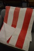 A red and white striped quilted bed throw, 235cm x 200cm.