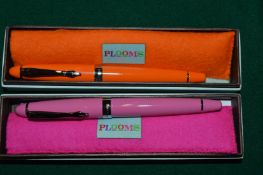An orange and pink Plooms fountain pens, boxed.