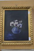 Still life of pansies in a vase, oil on board in a decorative gilt frame.
