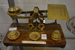 A good set of brass postal scales and weights.