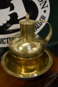 A very large brass lidded jug and bowl.