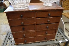 A table top chest of drawers.