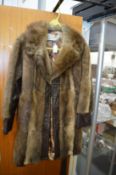 A ladies fur trimmed leather coat.